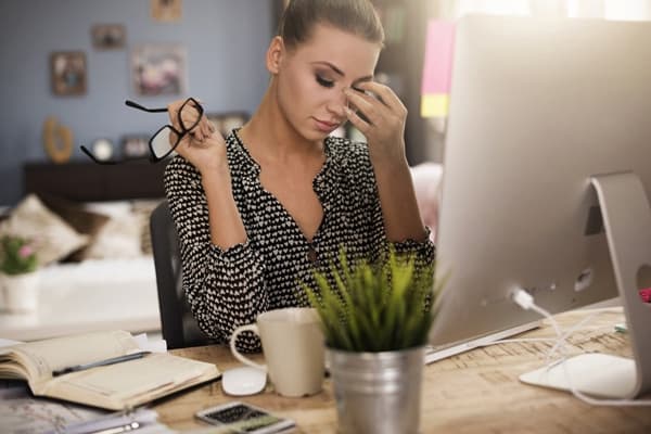 Young woman looking stressed out in front of a computer in Owensboro, Kentucky.