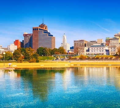 a body of water with a city in the background