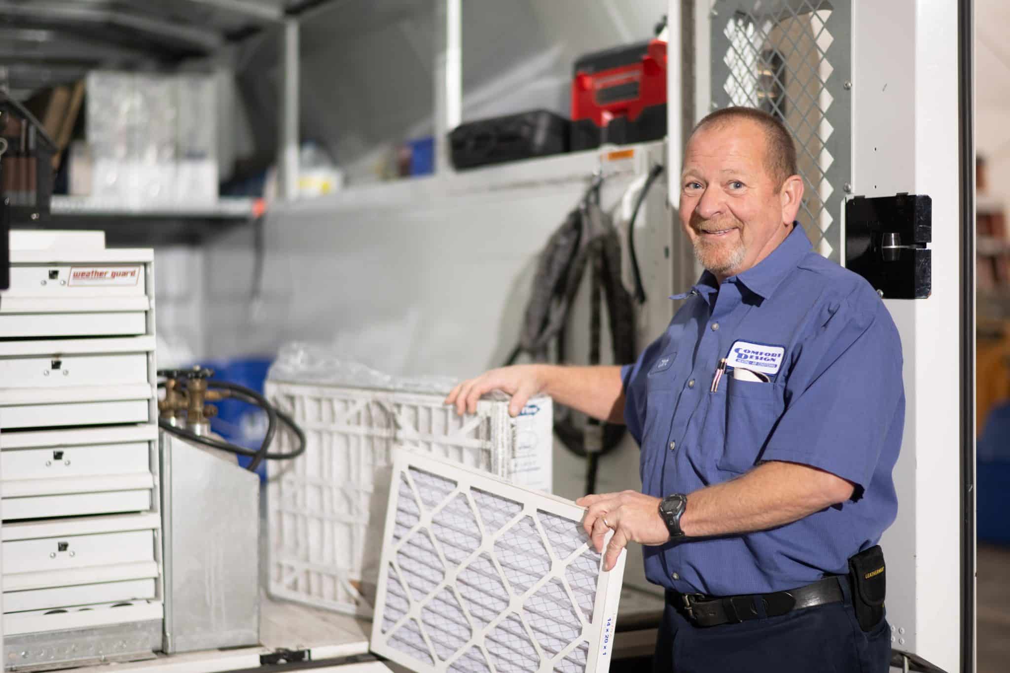 old man holding an air filter