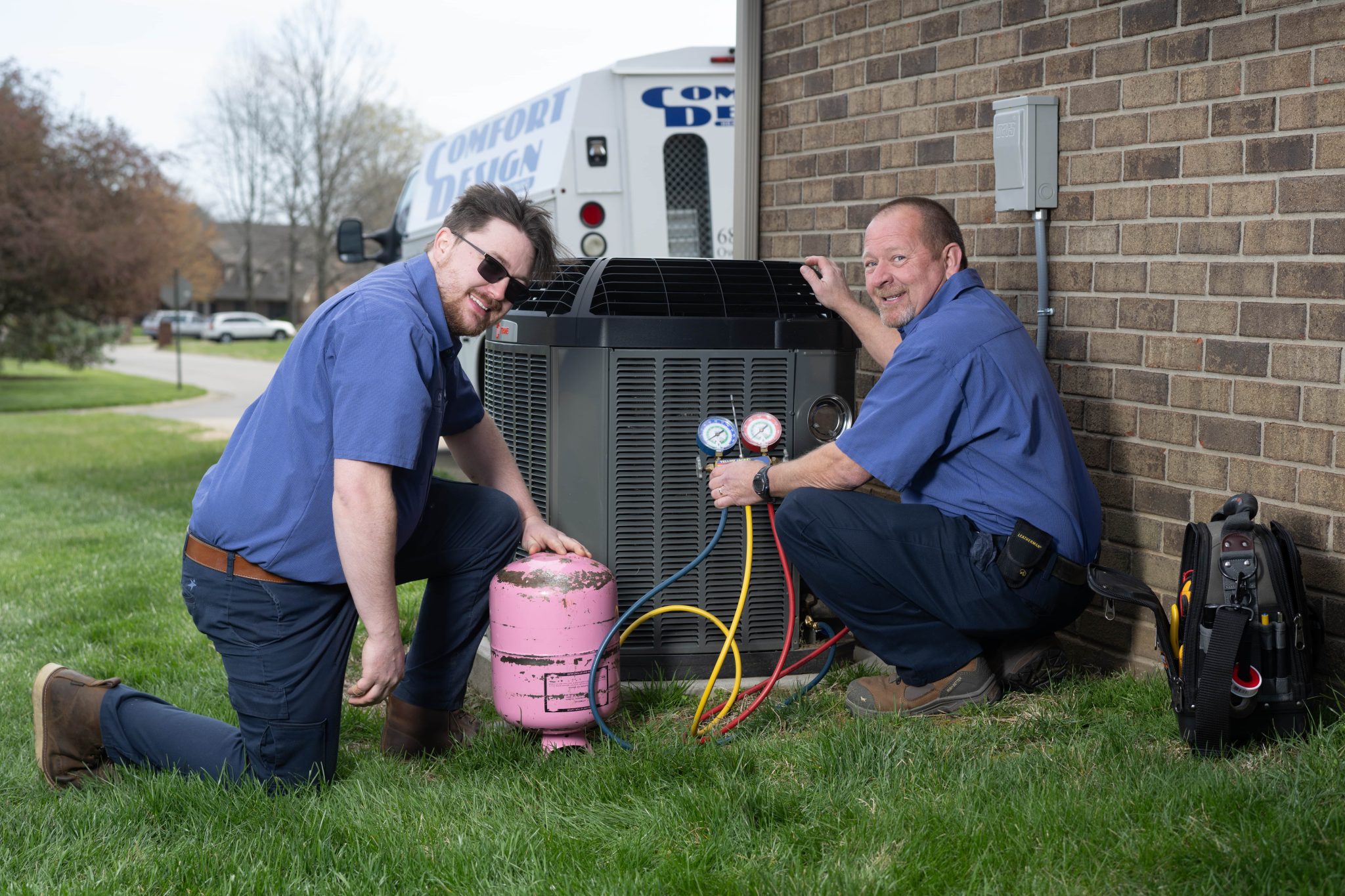 two men working on AC Unit