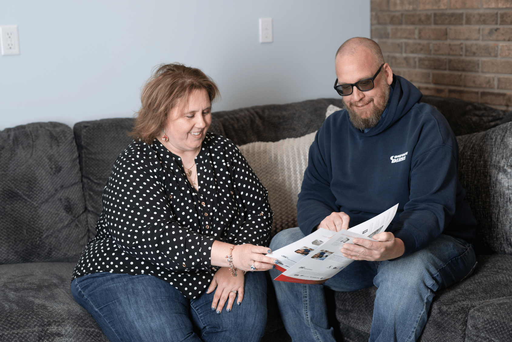 Two people reviewing a document together.